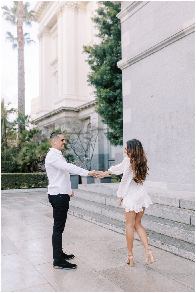 a couple dancing in front of the Capitol building for their Sacramento engagement session