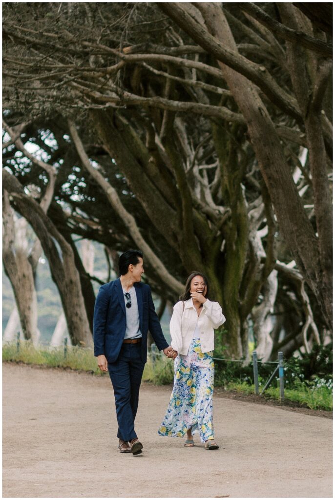 woman walking with her boyfriend turns the corner to see a proposal setup