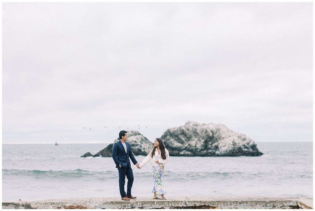 couple walking along the sutro baths