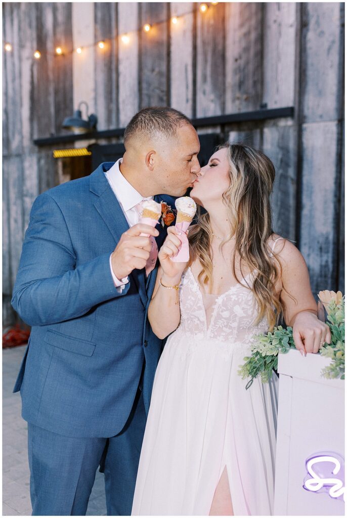 couple kissing while holding an ice cream at their lamoure vineyard wedding