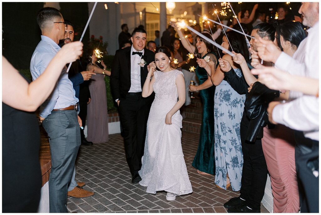 Bride and groom running through their sparkler exit.