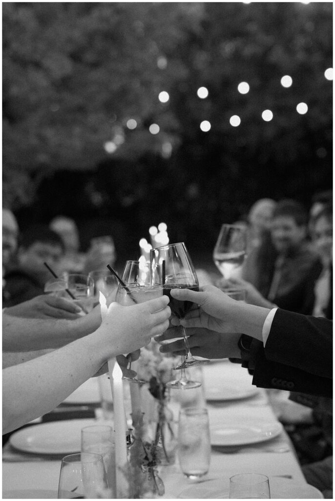 Black and white image of people toasting during a reception at Park Winters.