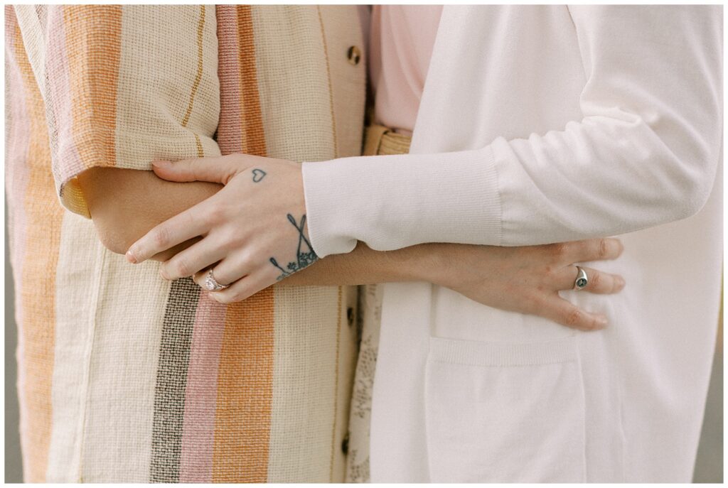 Close-up perspective of engaged couple's arms