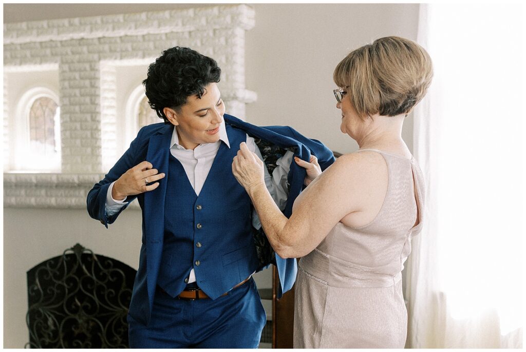 Mother of the bride helps her daughter get dressed.