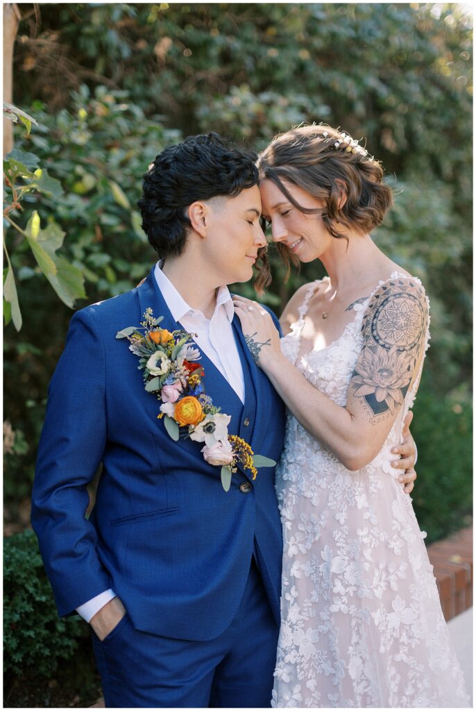 Brides resting their foreheads together during portraits.